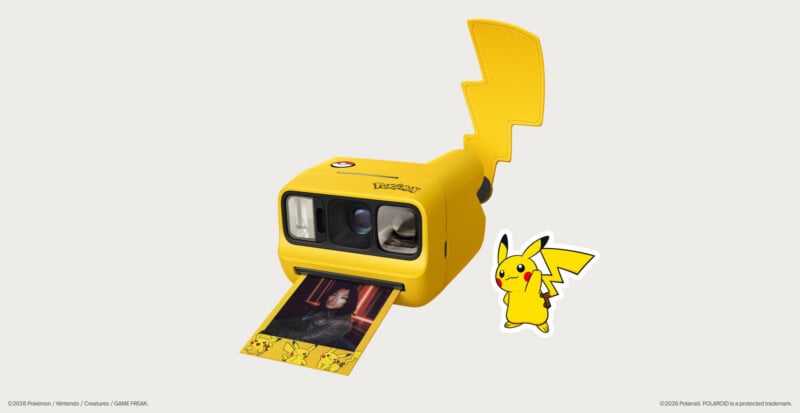 A yellow instant camera featuring a Pikachu tail attachment and a Pokémon logo, ejecting a photo with a Pikachu-themed border.