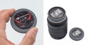 A hand holds a gray camera body cap with a DJI Ronin 4D-8K sticker, next to a camera lens with a custom "MY NAME IS HOWDY I MAKE VIDEOS" cap.