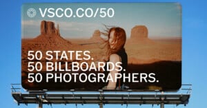 A billboard against a blue sky features a woman with windblown hair standing in a desert landscape with rock formations, with the text "VSCO.CO/50" and "50 STATES. 50 BILLBOARDS. 50 PHOTOGRAPHERS.