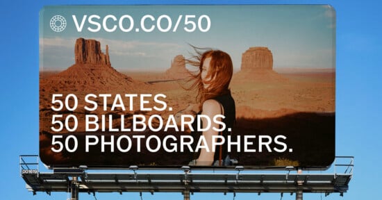 A billboard against a blue sky features a woman with windblown hair standing in a desert landscape with rock formations, with the text "VSCO.CO/50" and "50 STATES. 50 BILLBOARDS. 50 PHOTOGRAPHERS.