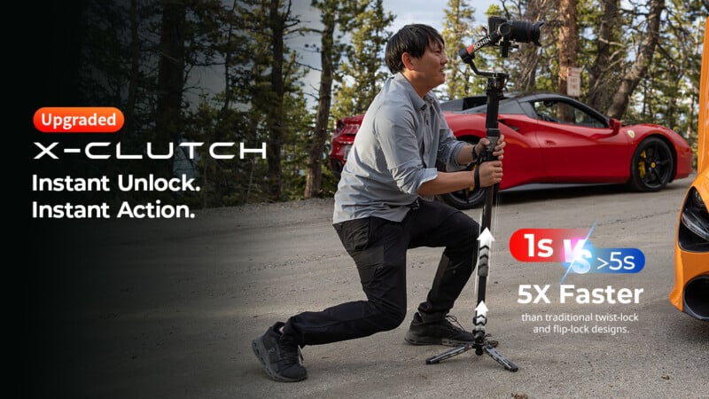 A person in a light shirt and dark pants kneels on a road while holding a camera stabilizer, with a red sports car parked in the background.