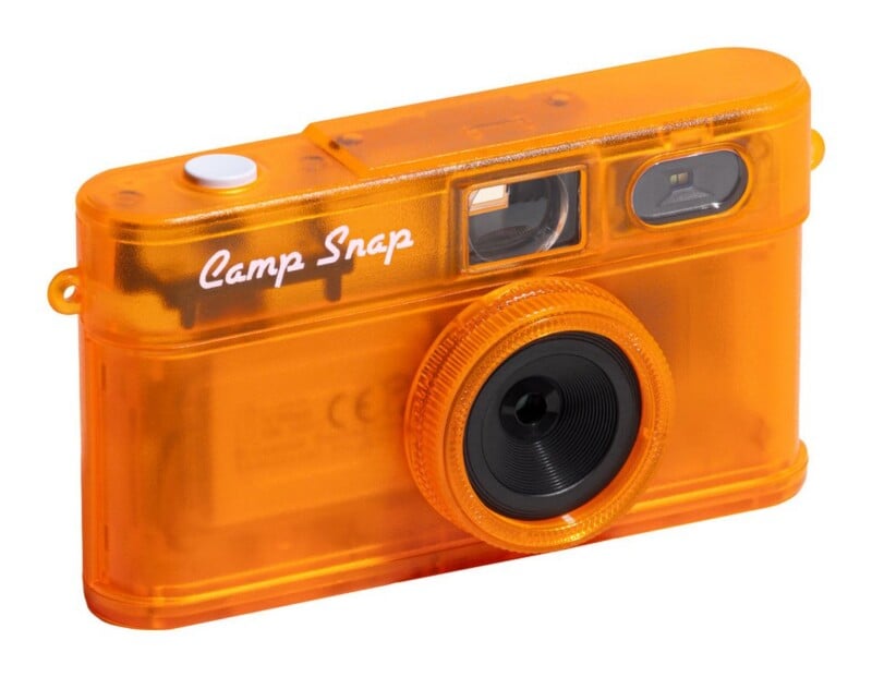 A translucent orange digital camera with a white shutter button and the text "Camp Snap" printed on the front.