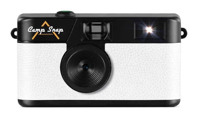 A white, textured digital camera with a black lens, viewfinder, flash, and the text "Camp Snap" on the front.