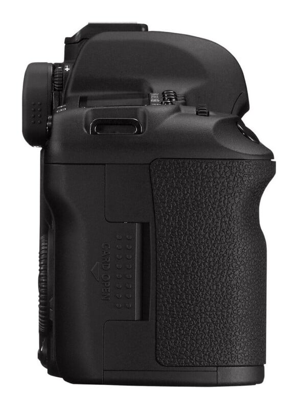 A side view of a black digital SLR camera body showing the textured hand grip and the memory card slot door labeled "CARD OPEN.