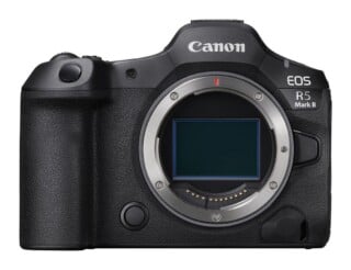 Front view of a black Canon EOS R5 Mark II mirrorless camera body with the lens detached, revealing the sensor and lens mount.