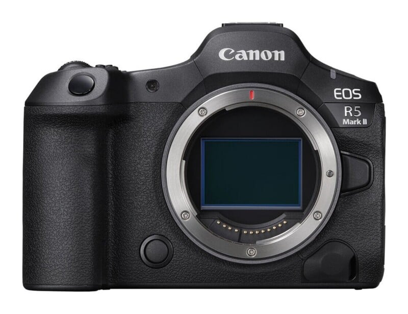 Front view of a black Canon EOS R5 Mark II mirrorless camera body with the lens detached, revealing the sensor and lens mount.