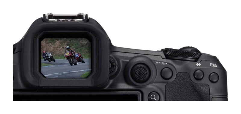 A close-up view of the back of a digital camera, showing a viewfinder displaying a motorcycle race and various control buttons.