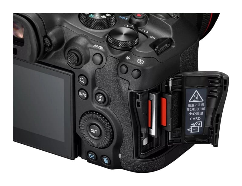 A close-up view of the back of a digital camera with its memory card slot door open, revealing two memory card slots.