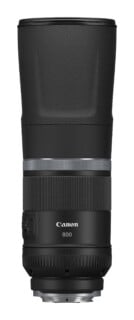 A black Canon 800mm telephoto lens stands vertically against a white background, showing its focus ring, control ring, and side switches.