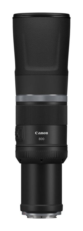 A black Canon 800mm telephoto camera lens shown from a front-facing perspective against a white background.