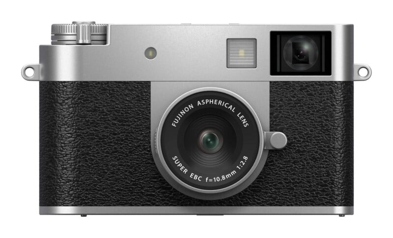 A silver and black digital camera with a fixed lens, viewed from the front, featuring text on the lens that reads "FUJINON ASPHERICAL LENS SUPER EBC f=10.8mm 1:2.8".