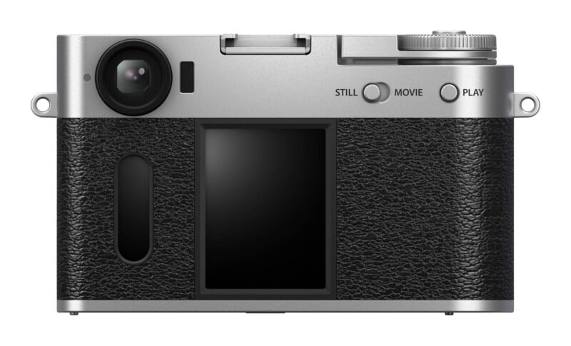 The back of a silver digital camera with a black textured grip, a central screen, a mode switch labeled STILL and MOVIE, and a button labeled PLAY.