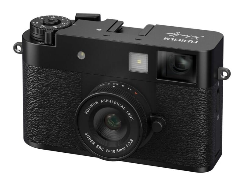 A black digital camera with a fixed lens, featuring a top-mounted exposure compensation dial and a Fujinon 10.8mm f/2.8 lens.