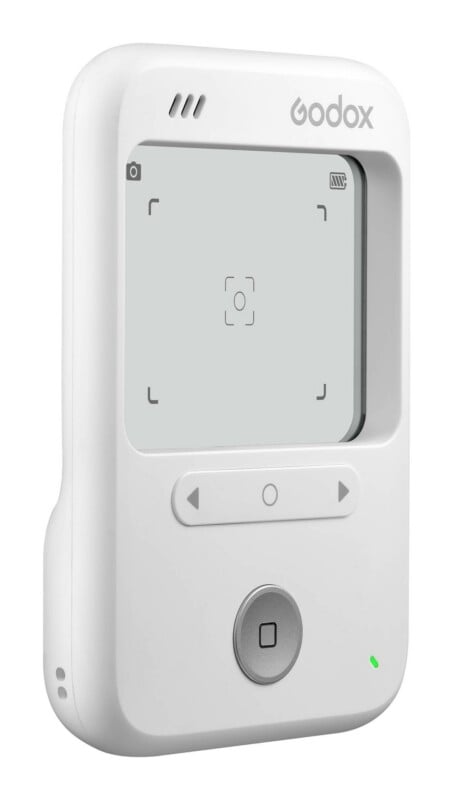 A white Godox device with a screen, navigation buttons, and a circular shutter button, shown against a white background.