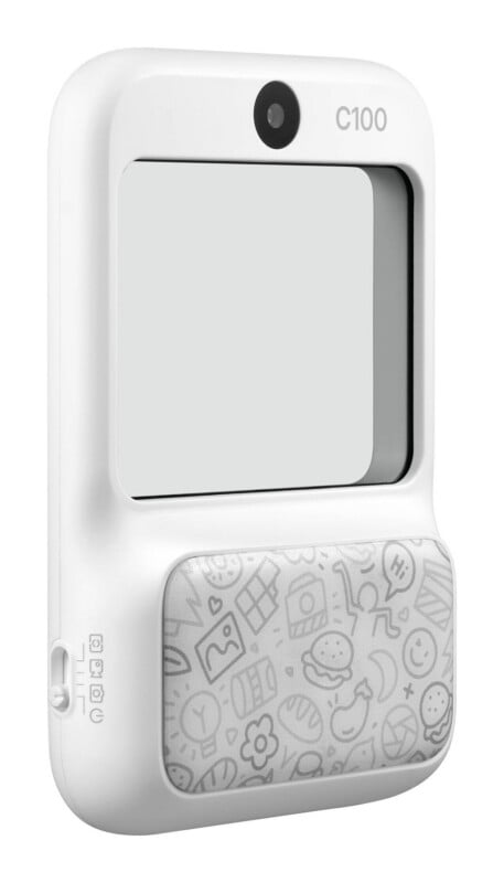 A white, rectangular digital camera with a lens at the top, a large screen, and a patterned lower section featuring various line-art icons.