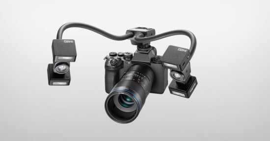 A digital camera with a macro lens is mounted with a dual-arm lighting system featuring two Godox MF-R76-style flash units.