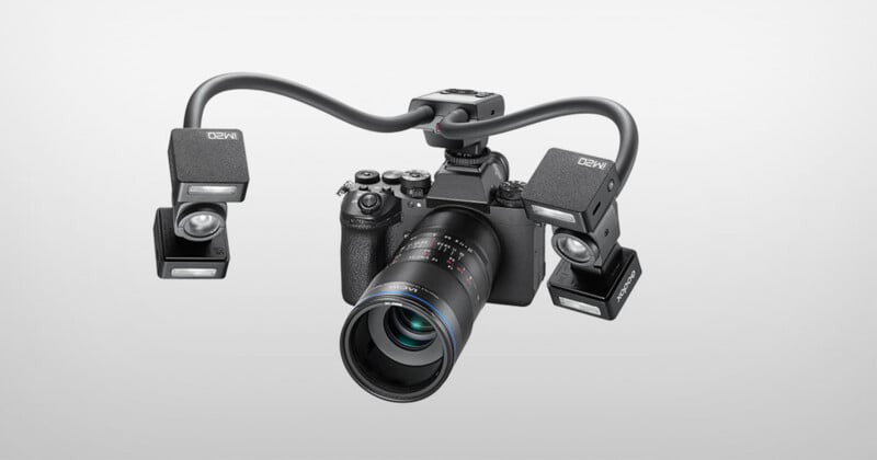 A digital camera with a macro lens is mounted with a dual-arm lighting system featuring two Godox MF-R76-style flash units.