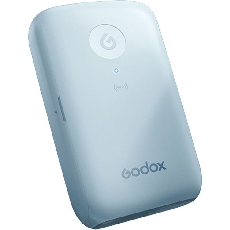 A light blue, rectangular Godox device with a circular power button, an NFC icon, and a small indicator light on its front surface.
