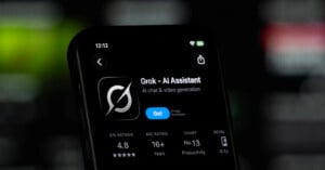 A smartphone screen displays the App Store page for "Grok - AI Assistant," showing a 4.8-star rating and a "Get" button.