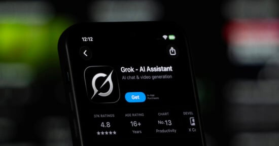 A smartphone screen displays the App Store page for "Grok - AI Assistant," showing a 4.8-star rating and a "Get" button.