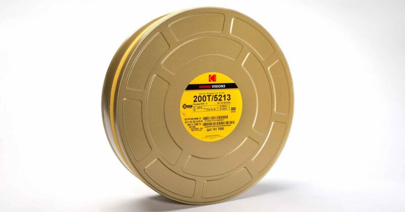 A gold-colored metal film canister with a yellow Kodak Vision3 200T/5213 label centered on its side.