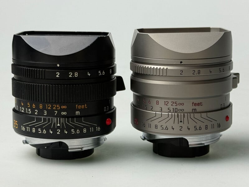 Two Leica Summilux-M 35mm f/1.4 ASPH lenses, one black and one silver, stand side-by-side against a plain white background.