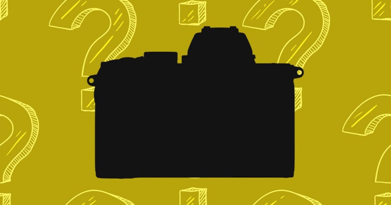 A black silhouette of a mirrorless camera centered against a mustard yellow background patterned with white line-art question marks and cubes.
