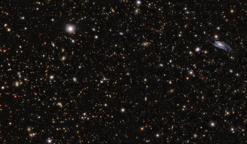 A dense field of thousands of distant galaxies of varying shapes, sizes, and colors scattered across a vast, dark expanse of space.