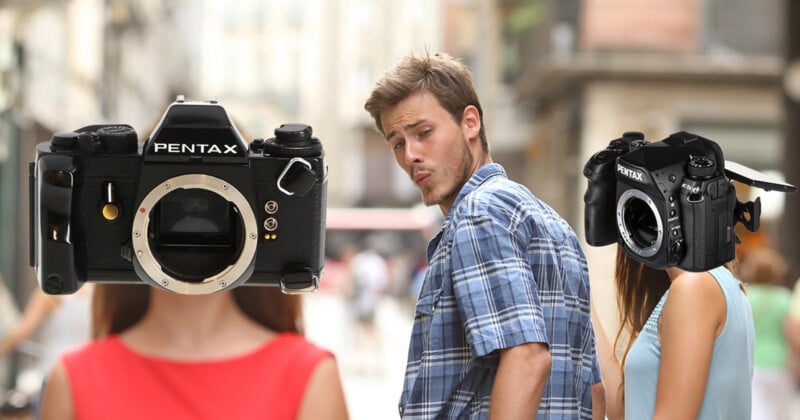 A man in a plaid shirt walks down a street, looking back at a woman with a Pentax K-1 Mark II camera for a head, while ignoring a woman with a vintage Pentax film camera for a head.