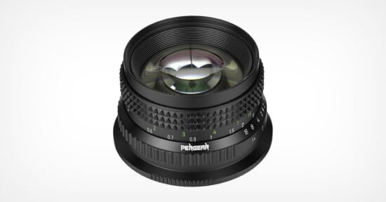 A black Pergear camera lens viewed from a high angle, showing its focus and aperture rings with white and green markings.