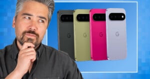 A man with graying hair and a beard rests his chin on his hand while looking at four smartphones arranged in a row behind him.