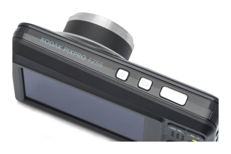 A top-down view of a black Kodak Pixpro FZ55 digital camera showing the power button, mode button, and shutter release button.