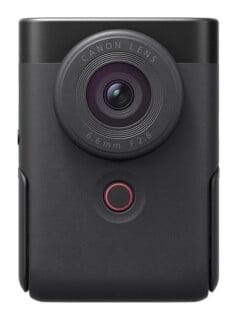 A front-facing black digital camera with a circular lens labeled "CANON LENS 6.6mm F2.8" and a small circular red-rimmed button below it.