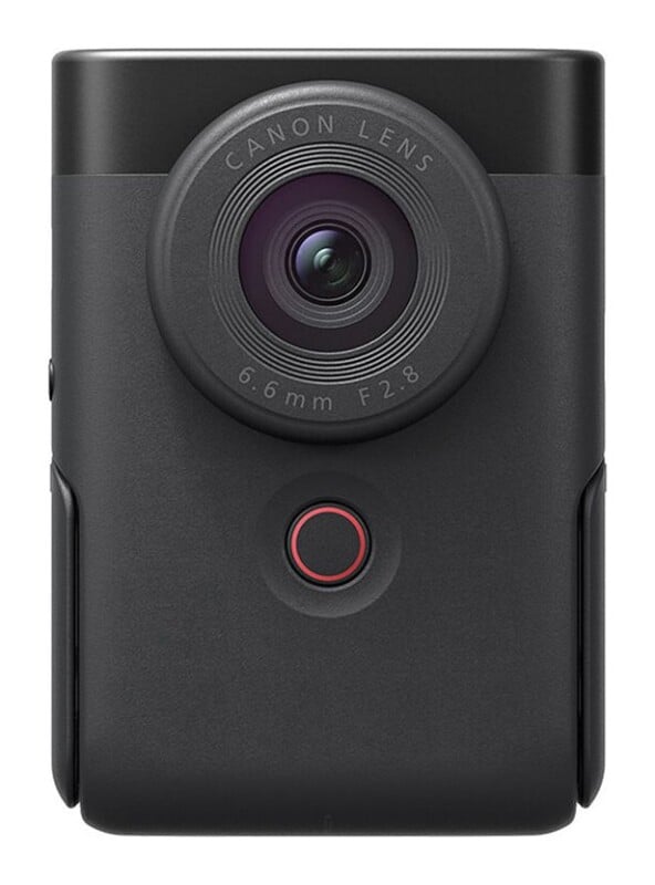 A front-facing black digital camera with a circular lens labeled "CANON LENS 6.6mm F2.8" and a small circular red-rimmed button below it.