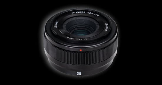 A black camera lens with a 35mm focal length, f/2.2 aperture, and 52mm filter thread, set against a solid black background.