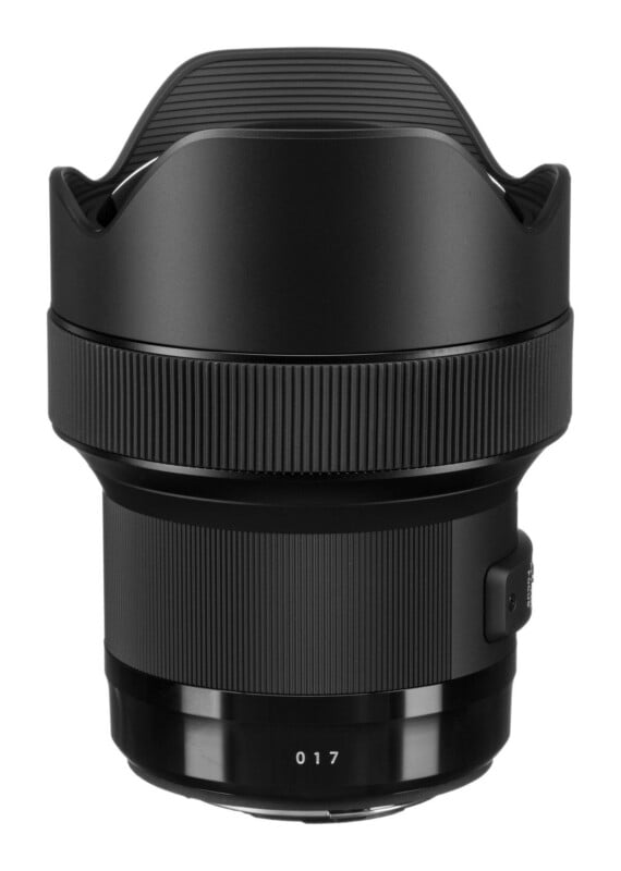 A black camera lens with a petal-shaped hood, a wide textured focus ring, and the number 017 printed near the base.