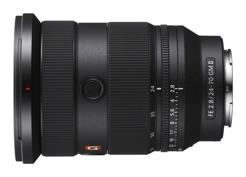 A black Sony FE 24-70mm f/2.8 GM II camera lens shown from the side, featuring a zoom ring, focus ring, and aperture ring.