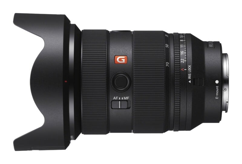 A black Sony FE 24-70mm f/2.8 GM II lens viewed from the side, featuring a lens hood, zoom and focus rings, an AF/MF switch, and an aperture ring.