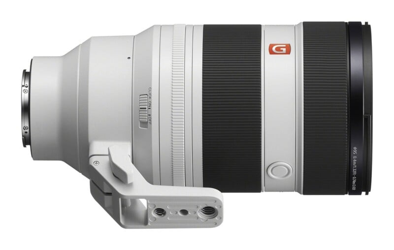 A white Sony G Master camera lens with a black focus ring, a tripod mount, and a switch labeled "CLICK ON" and "OFF" on its side.