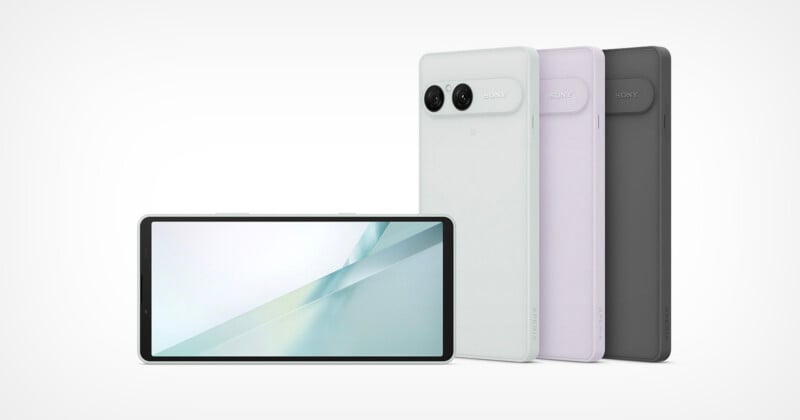 Four Sony Xperia smartphones are displayed against a white background, with one showing the front screen and three standing upright showing their rear camera modules in white, lavender, and black.