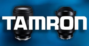 Two camera lenses are positioned against a blue background with the word TAMRON written in large white letters across the center.