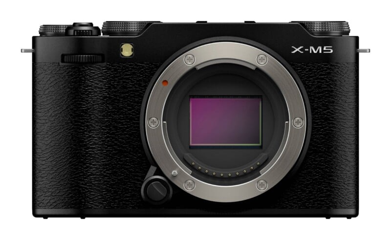 Front view of a black mirrorless camera body with an exposed sensor, a lens mount, and the text "X-M5" printed on the top right.