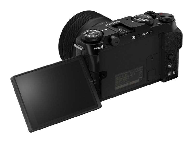 A black Fujifilm digital camera viewed from the rear, featuring a side-hinged articulating screen, a mode dial, and various control buttons.