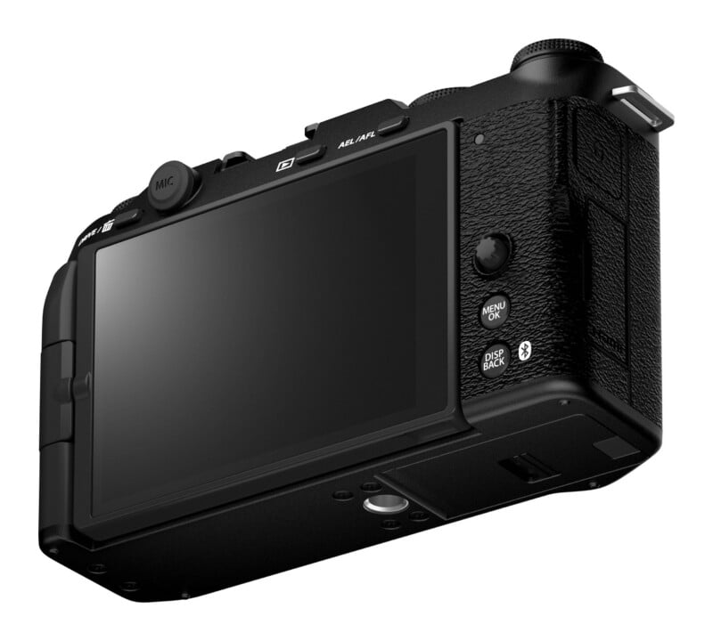 A black digital camera viewed from the rear, showing the LCD screen, control buttons, a joystick, and a microphone port.