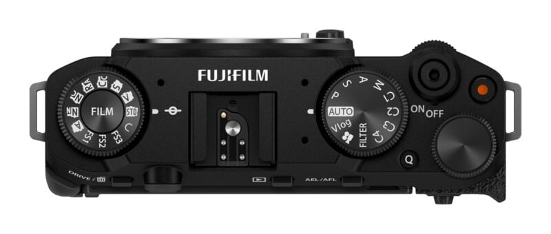 Top-down view of a black Fujifilm camera body showing the mode dials, shutter button, and hot shoe mount.