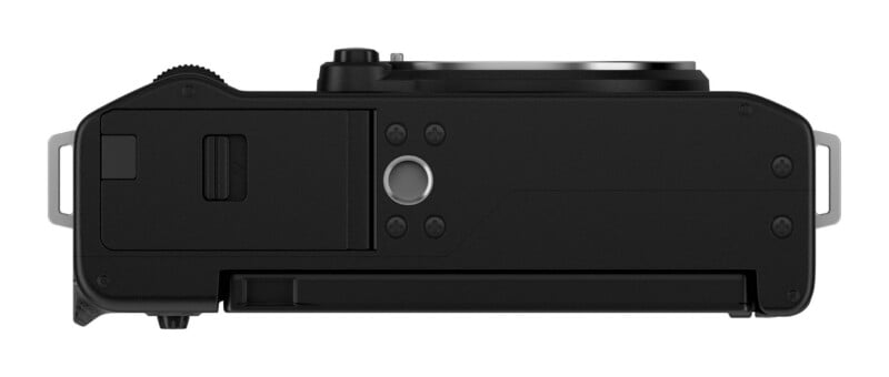 A bottom view of a black digital camera showing a battery compartment door, a central tripod mount, and metal strap lugs on either side.