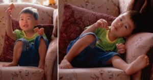 A young child in a green shirt and blue shorts sits on a patterned couch, holding and eating a small square cracker in two different poses.
