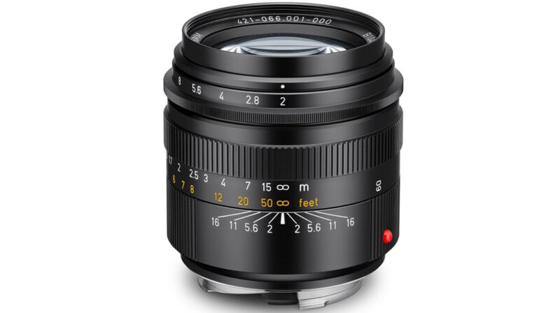 A black camera lens with a manual focus ring, aperture ring, and depth-of-field scale, featuring white and yellow text markings.