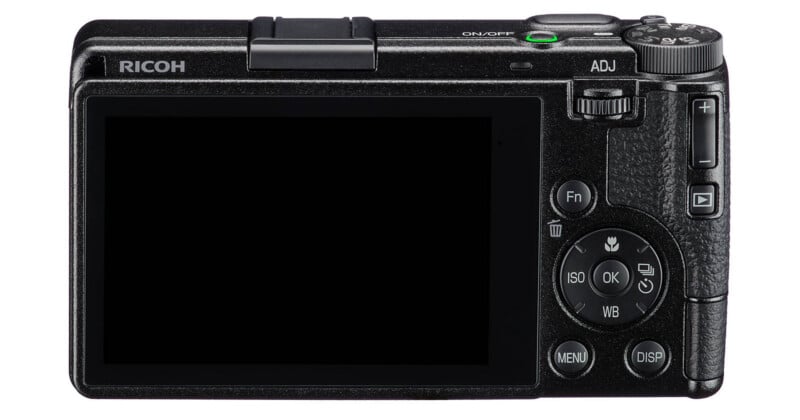 The back of a black Ricoh digital camera featuring a large LCD screen, a mode dial, an ADJ dial, and various control buttons including Fn, Menu, Disp, and a directional pad with an OK button.