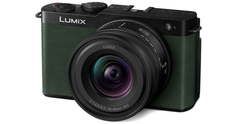 A green and black Lumix mirrorless camera with an 18-40mm lens attached, viewed from the front-right angle.